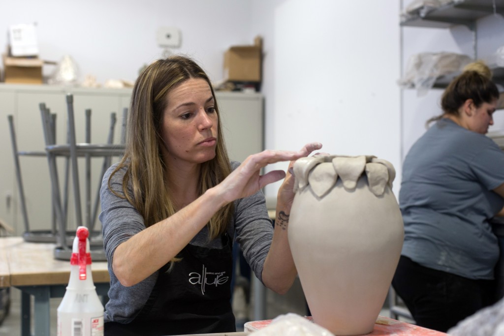 City College student Alysa Thomas, biology major, attaches a petal to her vase in her ceramics class in the Fischbacher Fine Arts Building. Hector Flores, Staff Photographer. | hectorfloresexpress@gmail.com