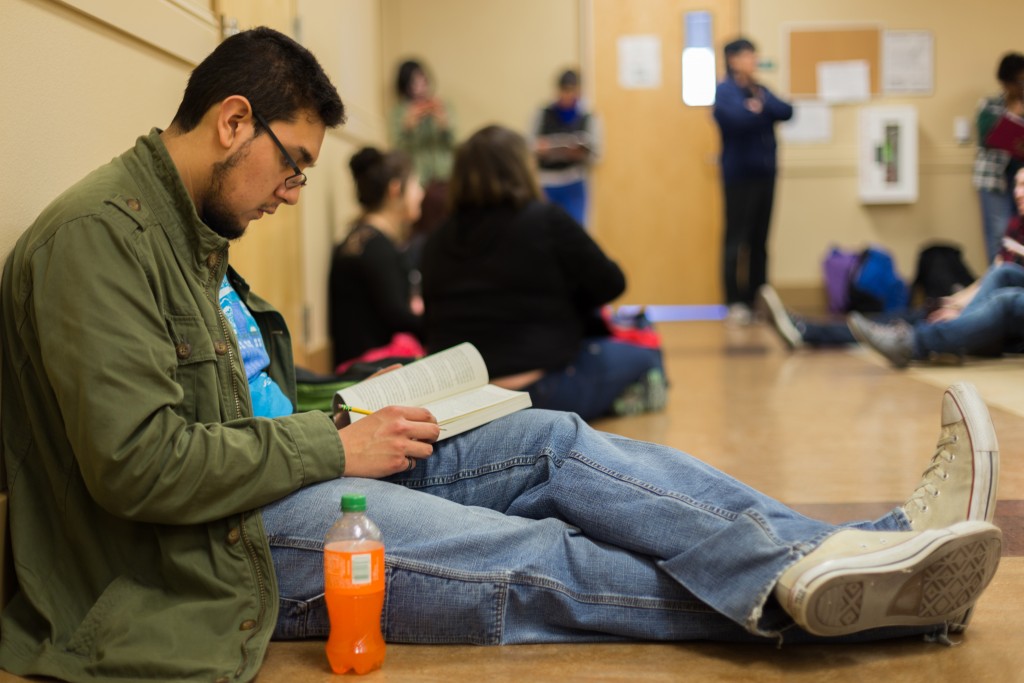 City college student, Carlos M. Alfaro, graphic communications, reads in a hallway in the Performing Arts Center as he awaits for his Color Theory class. Hector Flores, Staff Photographer. | hectorfloresexpress@gmail.com