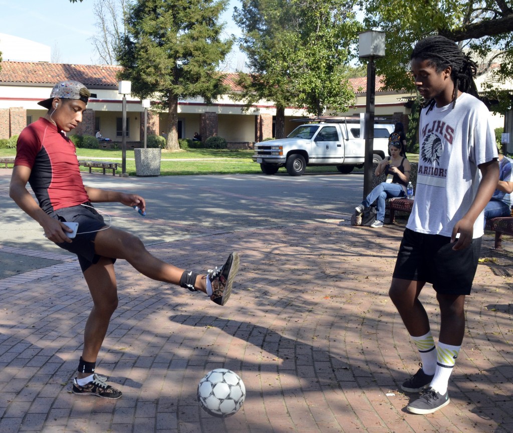 City College students Josh Hernandez, english major, and Malcolm Moore, graphic design major, warming up for their indoor soccer class. Barbara Williams, Staff Photographer. | BarbarajExpress@gmail.com