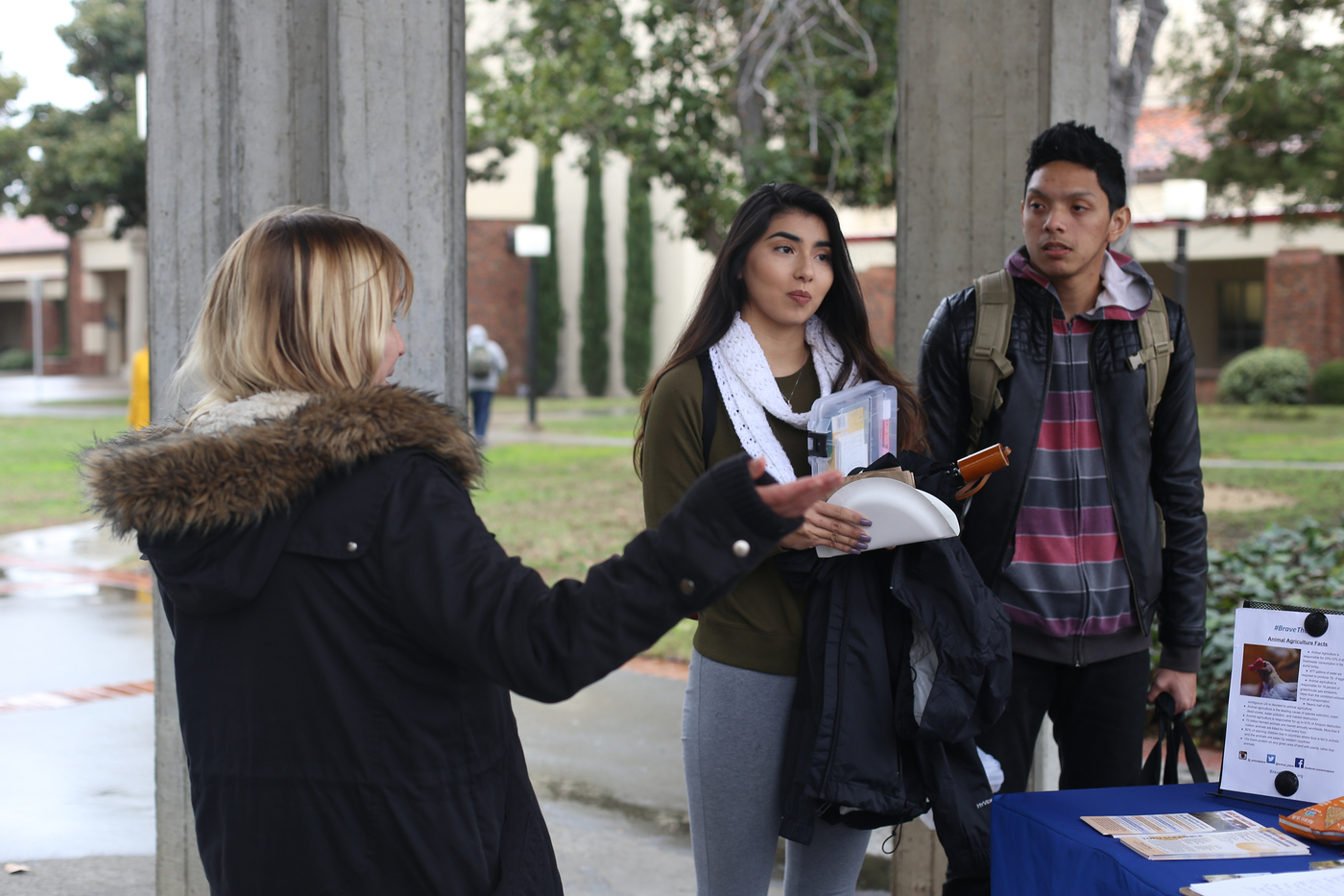 Stephanie Bain, outreach coordinator for Animal Place, talks to City College students Celina Ortega, environmental studies and sustainability major, and Kekoa Bajet, undeclared, about chicken abuse in factory farms Feb. 2, 2016. Hector Flores, Staff Photographer. | hectorfloresexpress@gmail.com