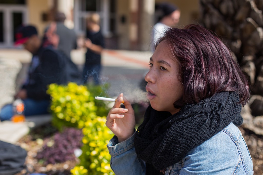 City College student Naomi Jones, pychology major, smokes a cigarette in front of the Performing Arts Center on March 14, 2016. Hector Flores, Staff Photographer. | hectorfloresexpress@gmail.com