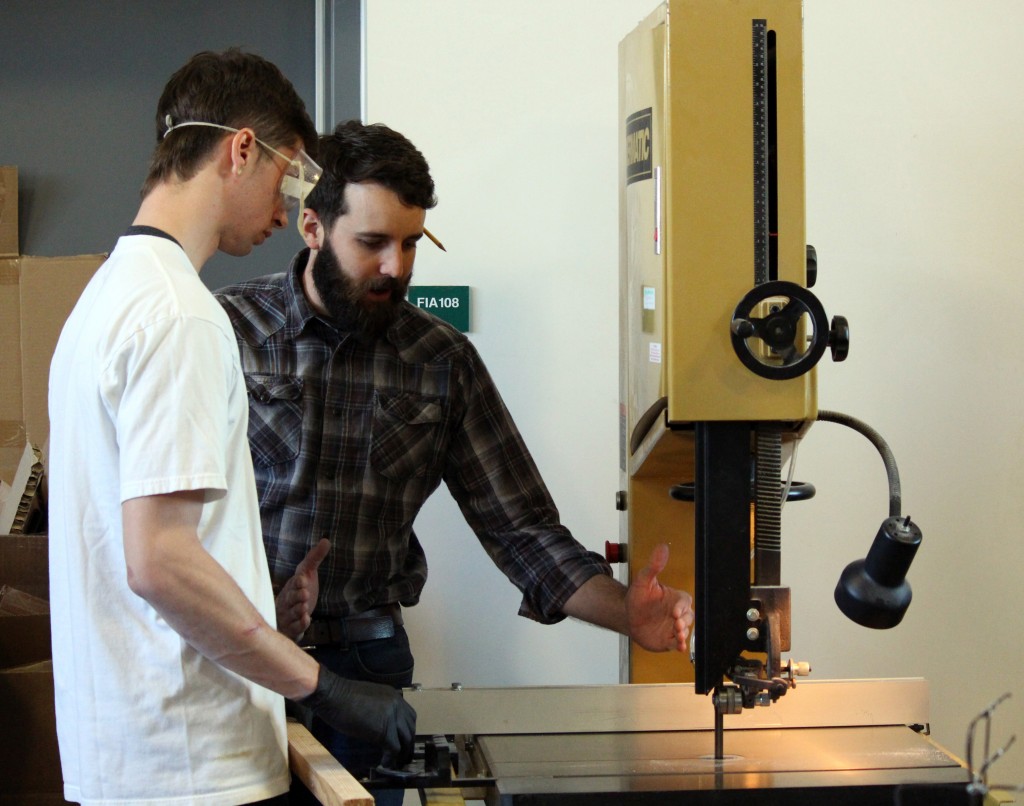 City College sculpture professor, Terry Peterson teaching Kegan Meyers, undecided major, how to get the correct angle on the band saw. Julie Jorgensen, Photo Editor. | juliejorgensenexpress@gmail.com