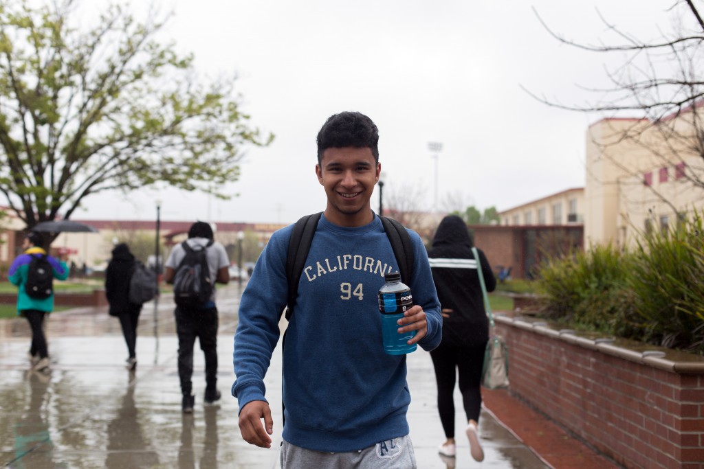 City College student Luis Razo, biology major, walks through the rain on the way to his math class. Hector Flores, Staff Photographer. | hectorfloresexpress@gmail.com