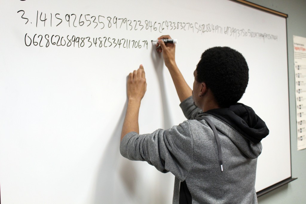 City College student Travell Criner, mathematic major, writting down the numbers of pi for the Pi Day contest. Julie Jorgensen, Photo Editor. | juliejorgensenexpress@gmail.com