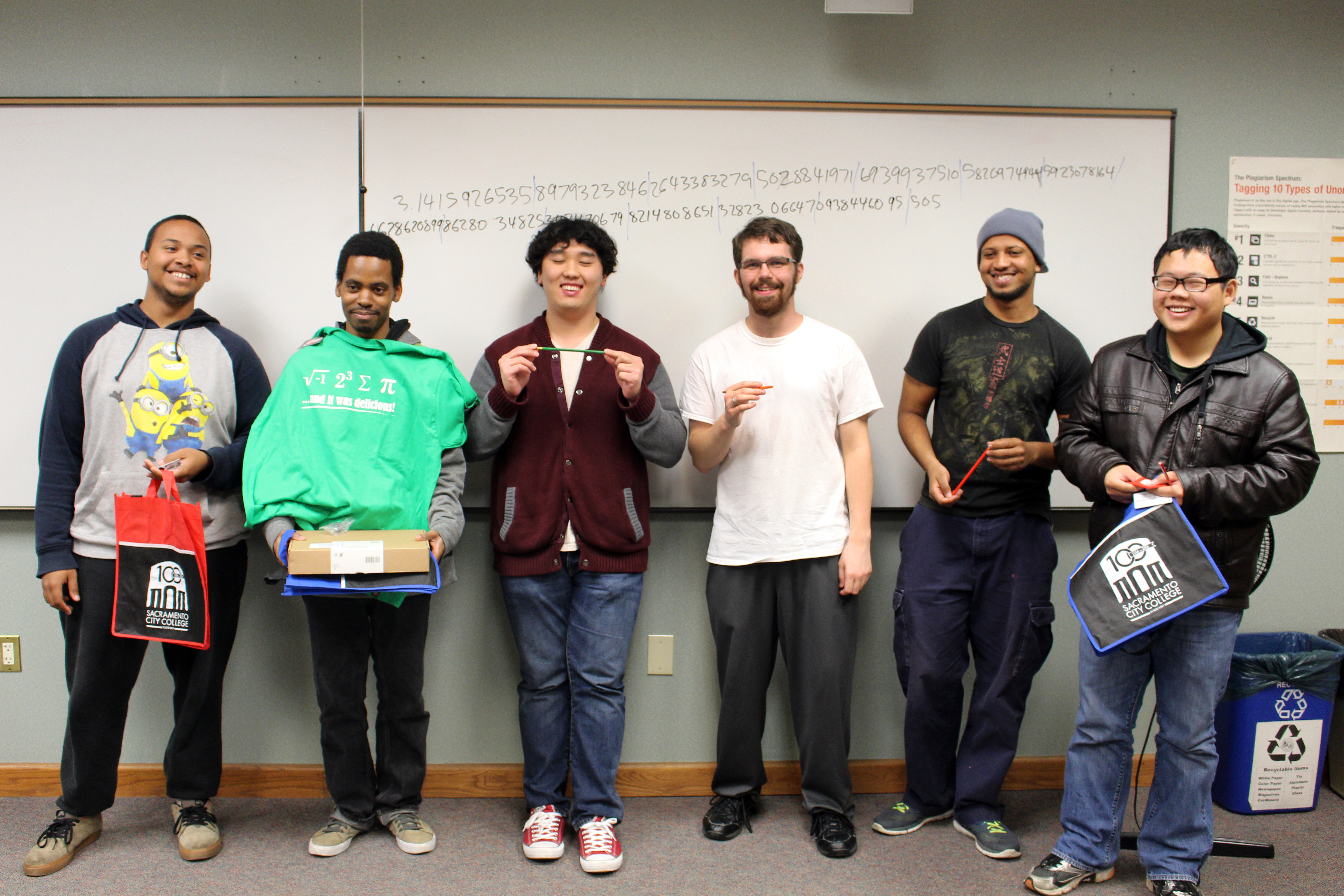 City College students Joshua Pauly (left), undeclared major, Travell Criner, mathemathics major, Andy Xiong, Chemistry major, Anthony Vanover, engineer design techonolgy major, Husham Haroun, computer science major, and Faren Li, accounting majo,r collecting their prizes after competing in the Pi Contest on March 14, 2016. Julie Jorgensen, Photo Editor. | juliejorgensenexpress@gmail.com