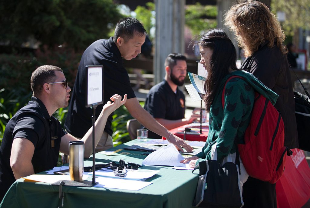 Enrollement Manager Jose A. Mejia speaking with XiaoXiao Yu a City College Freshman about trasfering to CSU Sacramento at Citys Transfer Day on March 18, 2015.