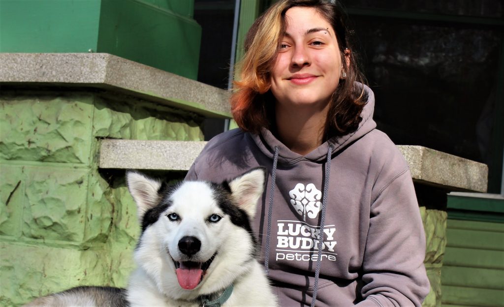 Anastasia Spitzer, 25, Lucky Buddy Pet Care employee and Sacramento City College student with her husky Roman.