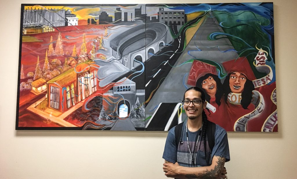 City College student and president of the Creative Alliance Club, Francisco Vasquez, in front of a painting he collaborated on. Jiaxin Lu | Staff Photographer | jlu.express@gmail.com