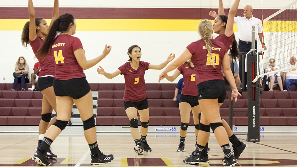 City College Volleyball team celebrates after winning the point in the first game of the match against Simpson University JV in the North Gym on Sept. 9th. ©2017 Dianne Rose