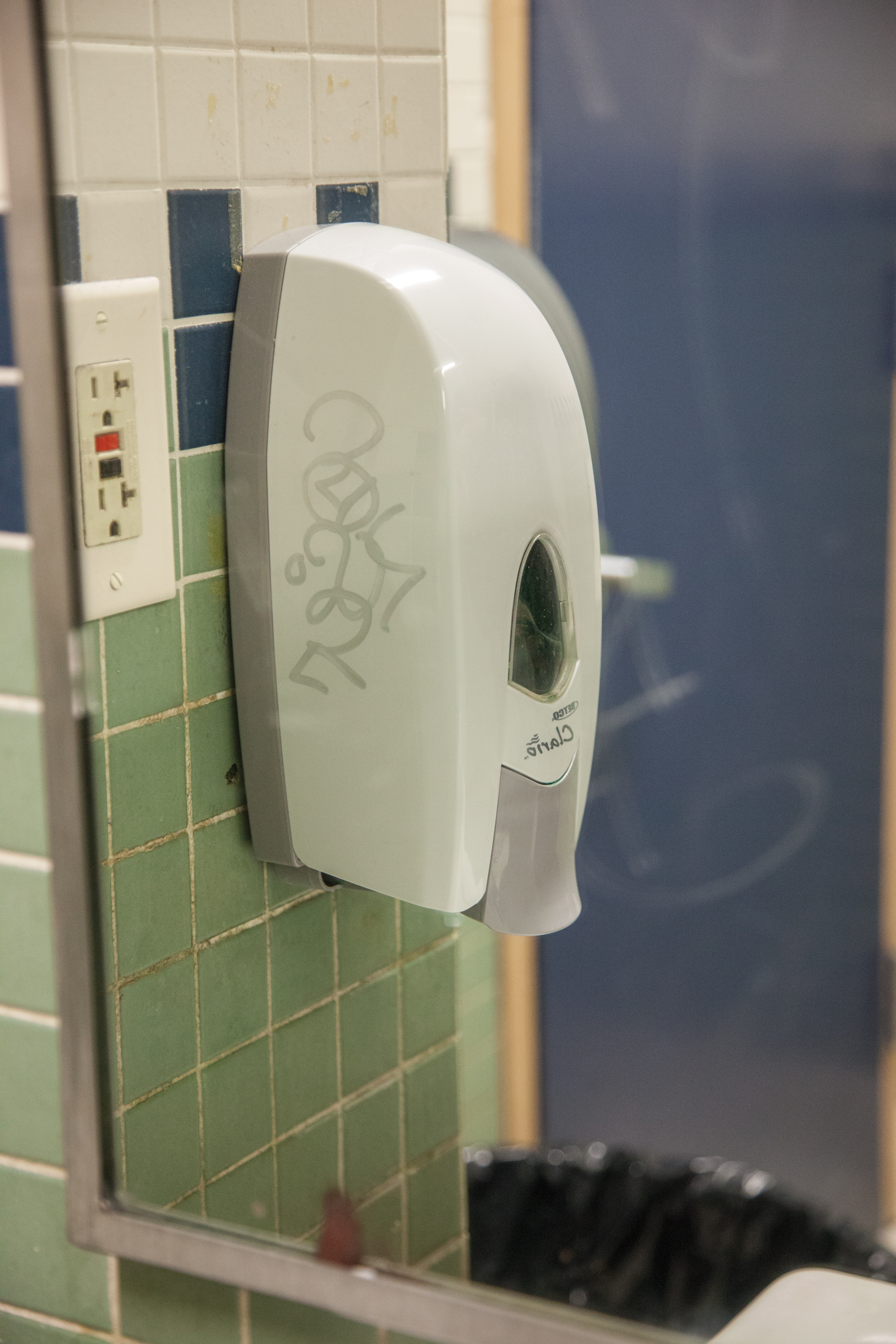 Graffiti adorns the soap dispenser inside the men's bathroom in the Lusk Center, accurately setting the tone for the unfortunate room. 