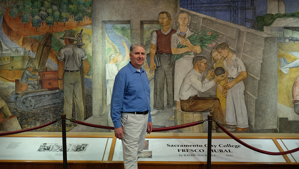 Bruce Marwick standing in front of the Fresco Mural located in the Performing Art Center. Jiaxin Lu | Staff Photographer | jlu.express@gmail.com
