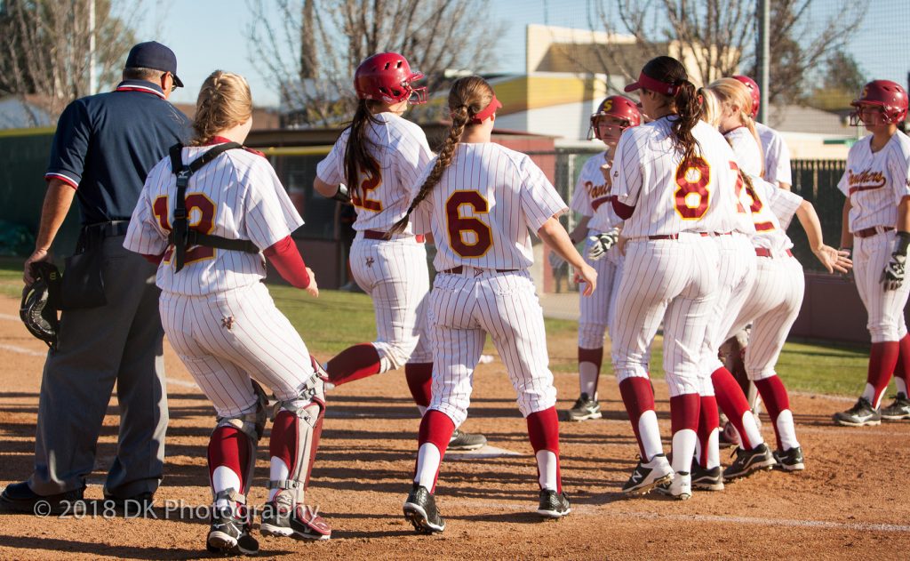 City College freshman Elizabeth Caffero is greeted by her teammates at home plate after crushing her third home run of the game, a walk-off grand slam,  against Lassen College Feb. 14 at The Yard. | Photo by Dianne Rose |  dianne.rose.express@gmail.com