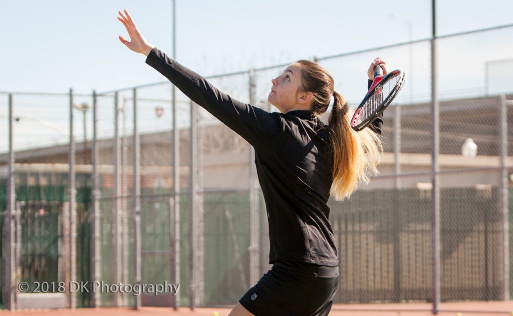 City College freshman Liliya Guslistova serves the ball during warm-ups before the Feb. 20 match against Sequoias at the City College tennis courts. | Photo by Dianne Rose dianne.rose.express@gmail.com