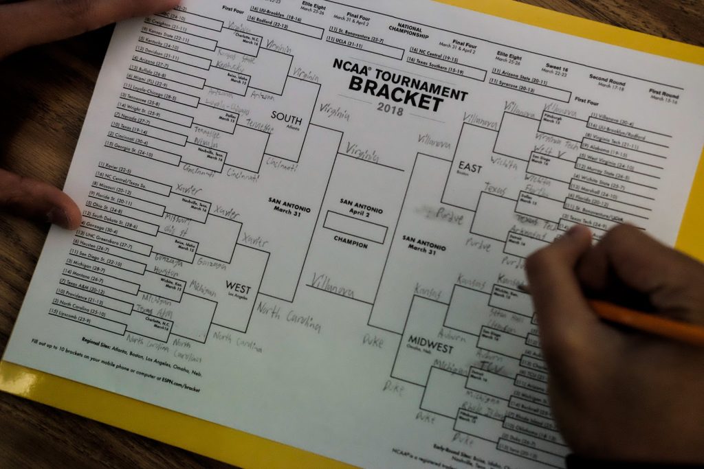 A City College student fills out an NCAA tournament bracket before the round of 64 begins Thursday morning. Express staff and City College coaches weighed in on who they thought would win this year's championship. | Photo by Phoenix Kanada | Staff Photographer | pkanada.express@gmail.com