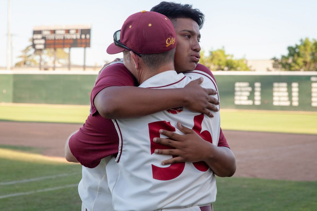 City pitcher Carlos Melero-Salaiz hugs pitching coach Deskaheh Bomberry after a 7-5 loss to San Joaquin Delta in the State Championship final May 28 at John Euless Park. The Panthers were the state runners up for the 12th time in school history. | Photo by Dianne Rose | diannekayphotos@gmail.com