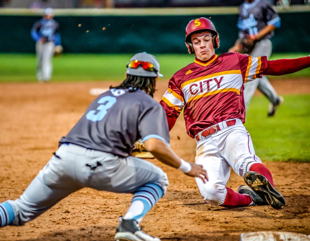 City College Anthony Galati (30) is safe as he slides into 3rd with Contra Costa Andruw Shaw (3) trying to tag him out in the bottom of the 4th inning in the Union Stadium on Thursday February 7, 2019.  City College beat Contra Costa College 8-1. Photo by Sara Nevis | Staff Photographer | snevis.express@gmail.com