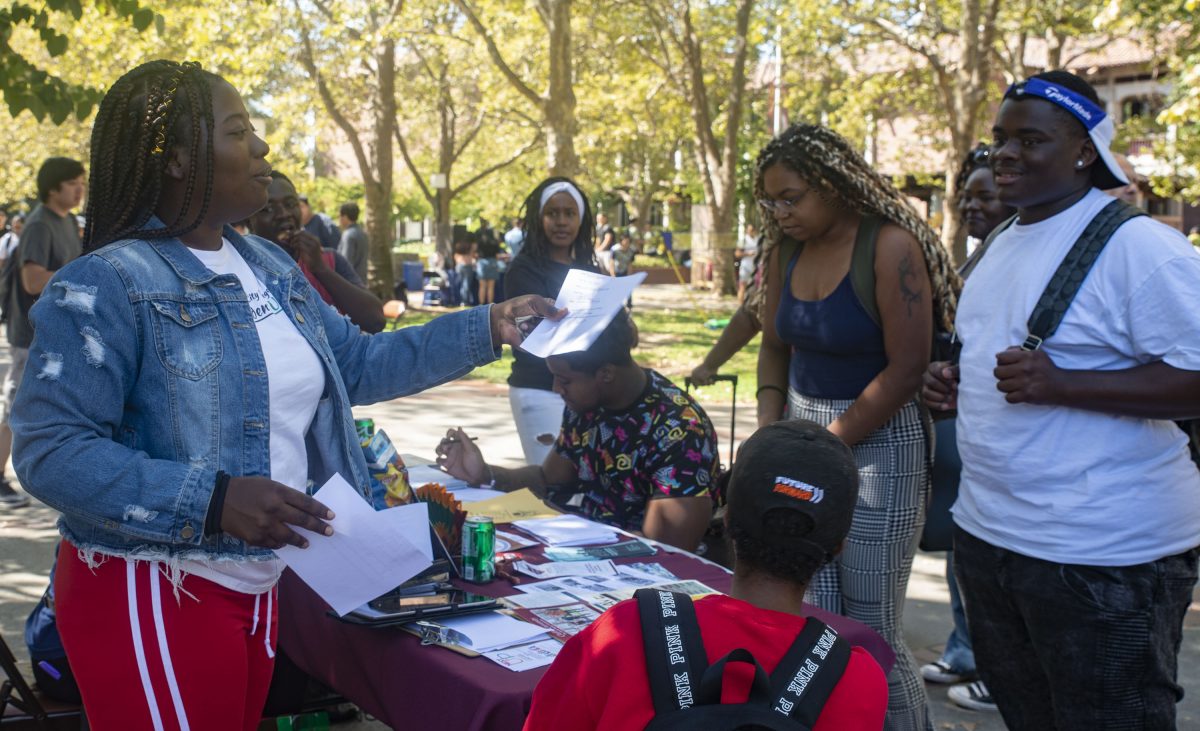 Taylor McClure, BSU president and journalism major, hands out information about BSU to a group of students during club day in the quad Thursday, Sept. 12, 2019. Photo by Melissa Sanchez Robinson | melissa.libertad@gmail.com