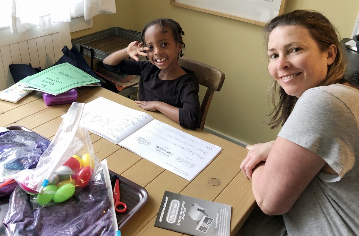 Sophia Estabrook, left, 5-year-old kindergartener, with her mom Terra Estabrook working on school work at their home in Sacramento, California Sunday, March 15, 2020. (Paul Estabrook family photo)