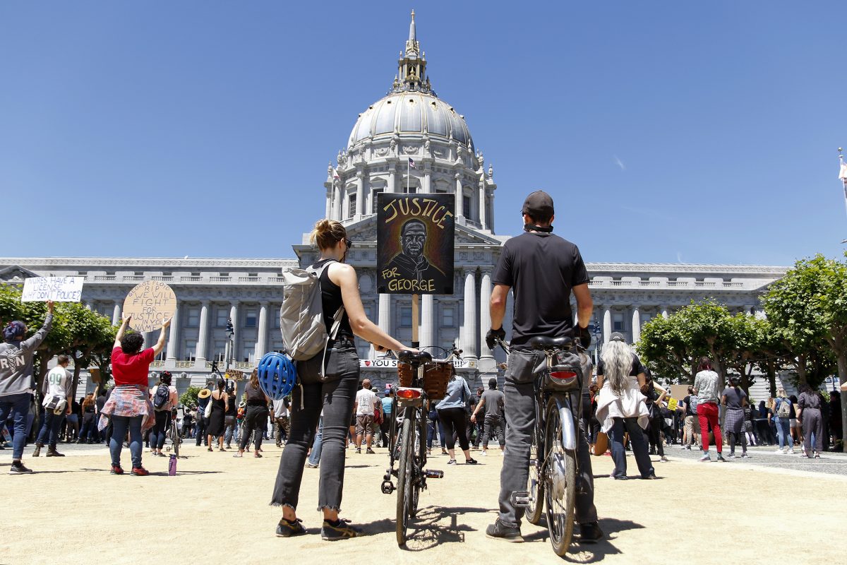 Jennifer Klecker and John Kelly, both from San Francisco, with their bikes at the Kneeling 4 Justice memorial and celebration of the life of George Floyd organized by Wealth and Disparities in the Black Community at San Francisco City Hall Tuesday, June 9, 2020. George Floyd was killed in Minneapolis after being detained by police May 25. Over 500 people were in attendance at the peaceful demonstration. (Sara Nevis/snevis.express@gmail.com)