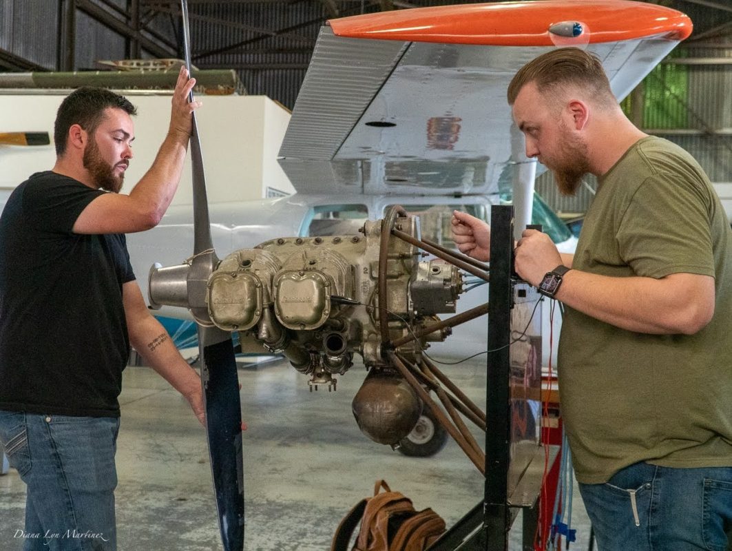 Aeronautics students Elijah Holland (left) and James Hammer (right) synchronize the propeller timing to the ignition system on an aircraft engine at City College’s McClellan Hangar facility located at Sacramento McClellan Airport. Photo Credit: Diana Martinez / dmartinez.express@gmail.com