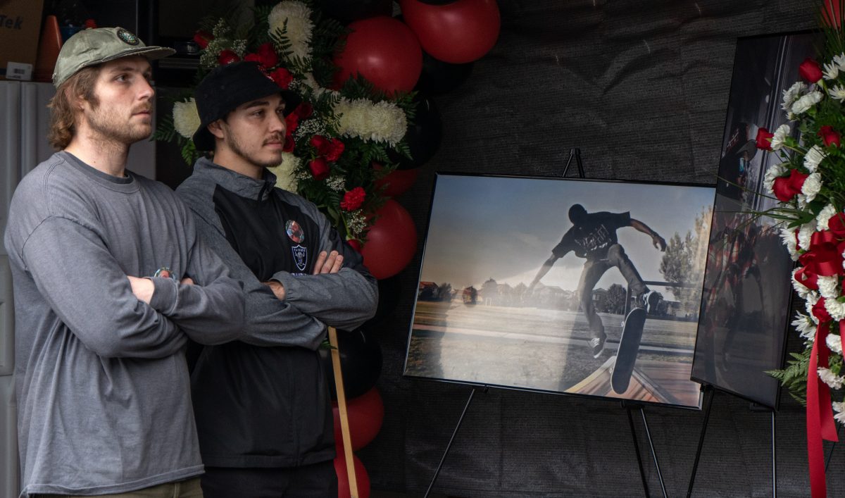 Ryan Thomas (left) and Nathan Bernal (right) observe guest speakers at the Home Going Celebration for Tyre Nichols held at the Sac Ramp Skate Shop on Saturday, Feb. 4, 2023. 
Photo credit: Manuel Figueroa / mfigueroa.express@gmail.com