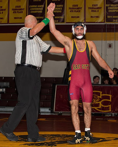 Sacramento City College wrestler Ammar Khan having his hand raised by a referee after getting a pin fall against a Shasta Knight opponent on Wednesday night, Oct. 25, 2023. Photo curtesy of Randy Martin 