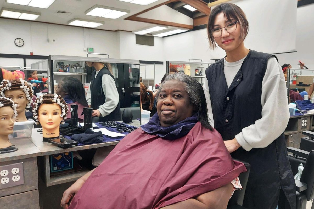 City College alumni Sheila Osborne has her hair done by City College cosmetology student Angela Pham on Feb. 14 2024. Pham has been working on mastering her new skill as a hairstylist.