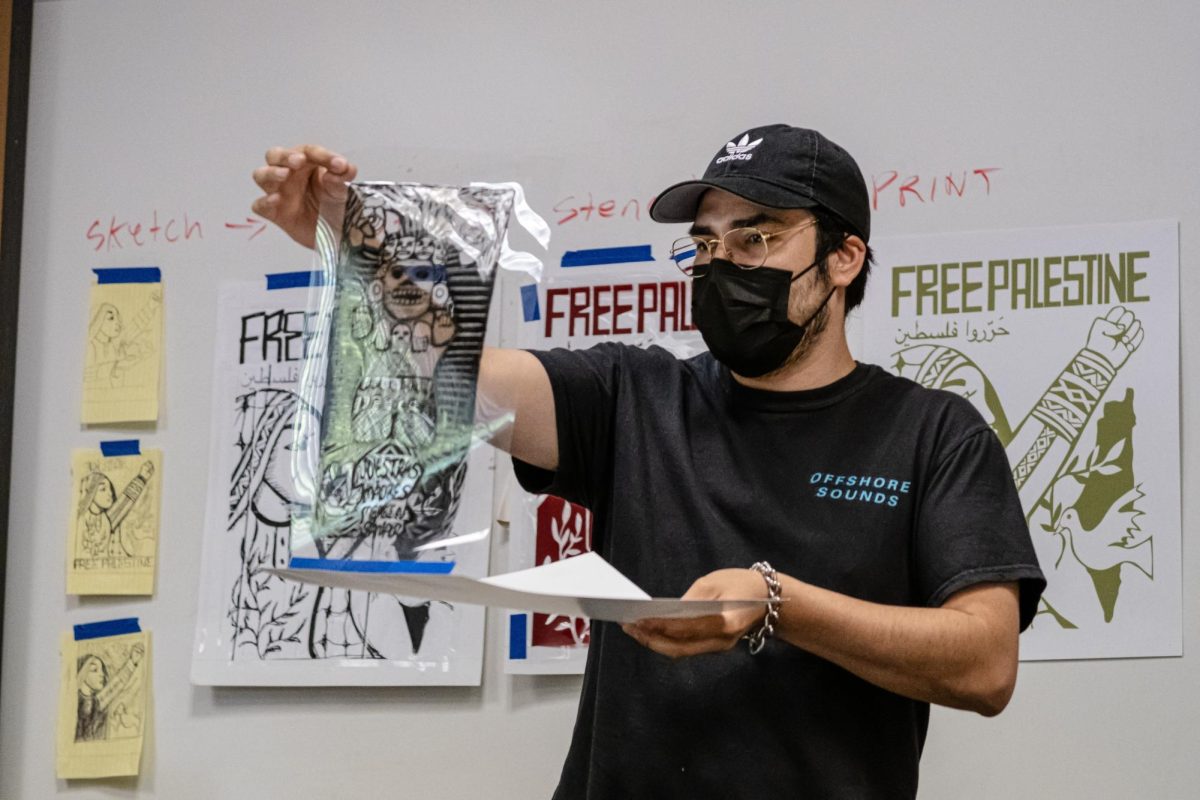 Artist Eddie Lampkin (Printingainteasy) speaks about the silk-screen printing process at the Serigrafía y Solidaridad event in the Learning Resource Center on April 22, 2024.