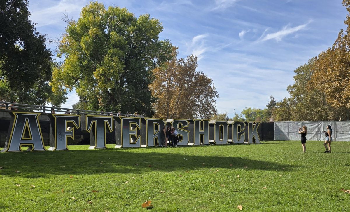 Concertgoers take photos in front of the Aftershock sign during the first day of the Aftershock music festival at Discovery Park on Thursday, Oct. 10, 2024, in Sacramento, Calif.
