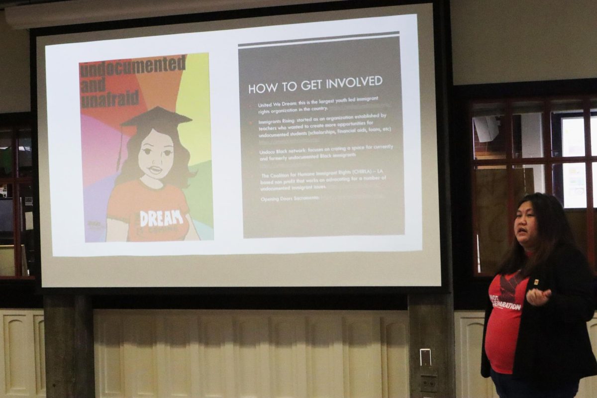 Sacramento City College sociology professor Belinda Lum presents slides at the I Stand with Immigrants Day of Action in the Student Center on Tuesday, Oct. 15, 2024, in Sacramento, Calif. 