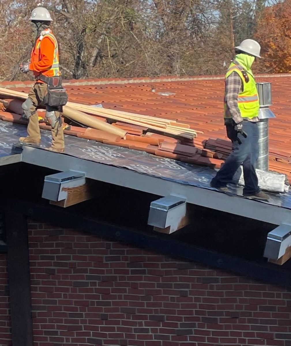 Construction workers replace tile on the roof of what will become the new Sacramento City College Student Health and Wellness Center on the morning of Monday, Dec. 2, 2024 in Sacramento, Calif.