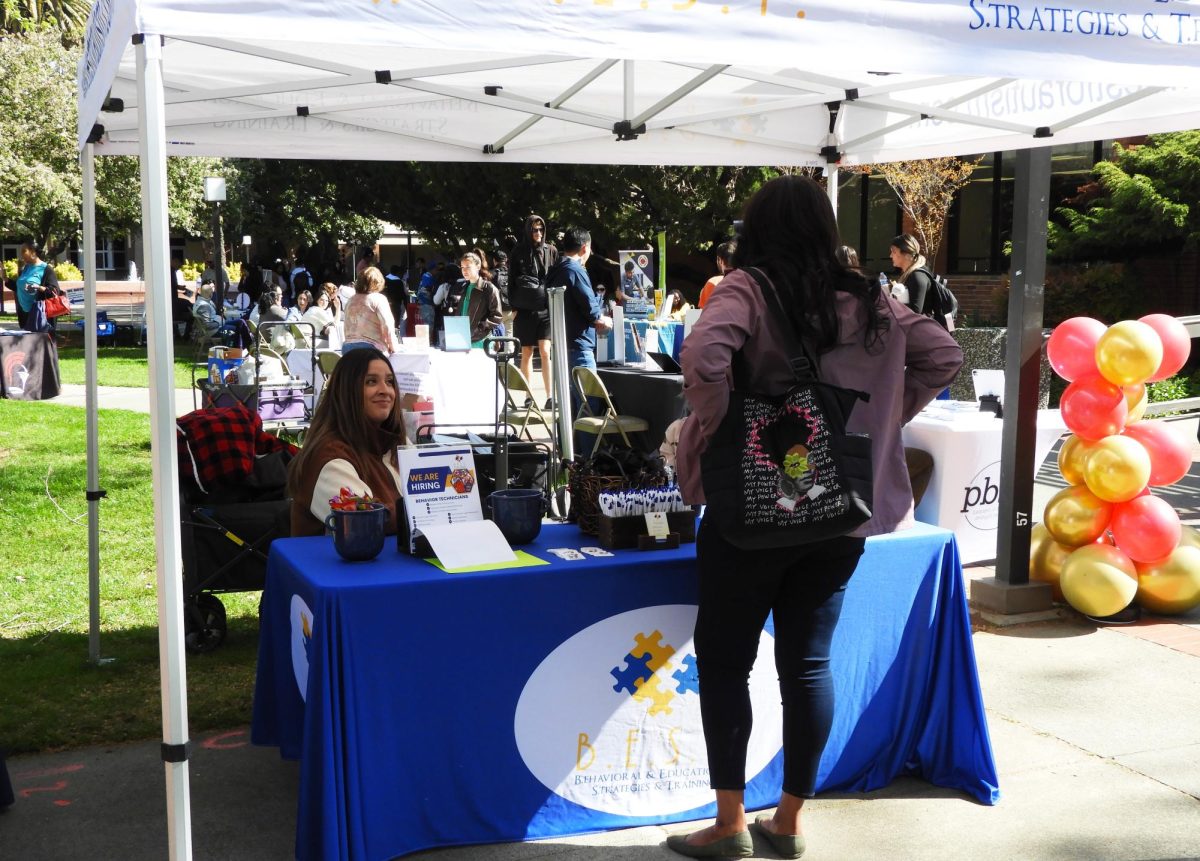 A student talks to the Behavioral & Education & Strategies & Training booth during the All Major Career Fair, Thursday, April 3, 2025, in Sacramento, Calif.