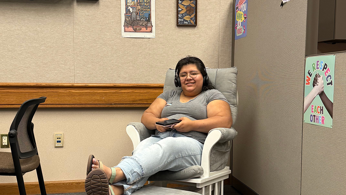 A City College student sits in a rocking chair in the Disability Cultural Center. Photo courtesy of Rachel Stewart and The Disability Cultural Center.