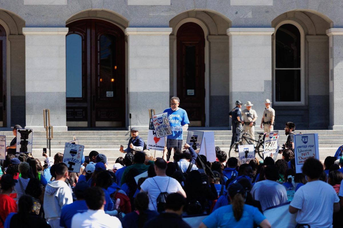 Marchers gather to listen to speakers for the “March in March” at the Capitol building Thursday, March 12, 2026, in Sacramento, Calif.