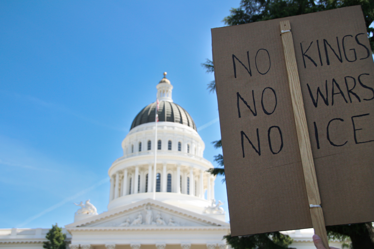 Protest sign held in front of Capitol building on March 28, 2026.
