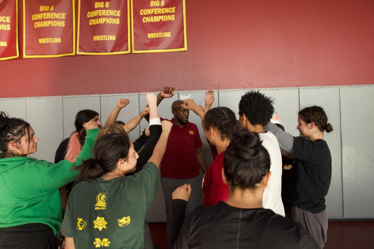 Sacramento City College women’s wrestling team members finish a practice session with head coach Marques Gales in the Wrestling Room in the North Gym on Wednesday, April 15, 2026, in Sacramento, Calif.